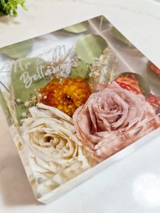 Personalised square resin block with preserved wedding flowers and engraved “Mr & Mrs Bellamy” text, ideal for wedding bouquet preservation.
