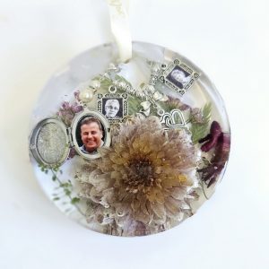 preserved wedding flowers in a resin hanging round disk ornament