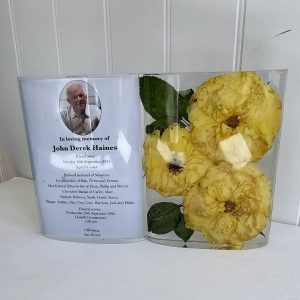 crystal clear resin funeral flower preservation in a book shape with order of service